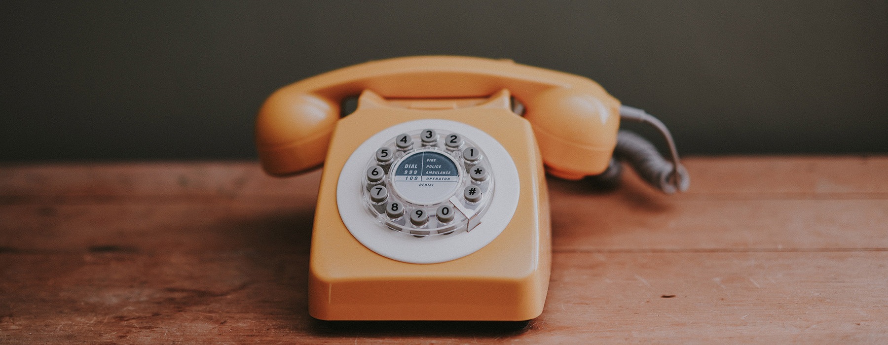 old phone sitting on a wooden table 