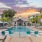 Resort-style swimming pool with lounge seating